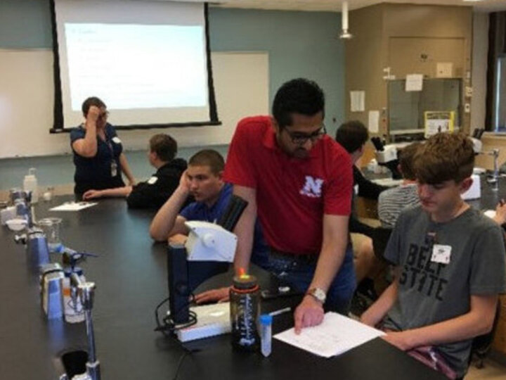 Sajjan discusses with student at Visits by Scientists Program for Lincoln Public Schools